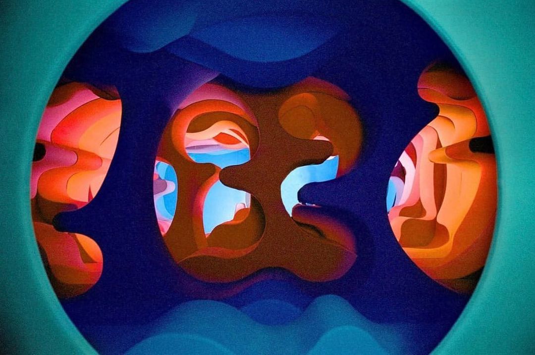 Abstract digital artwork featuring layered shapes and vibrant colors of blue, orange, pink, and teal, creating a surreal and captivating visual.