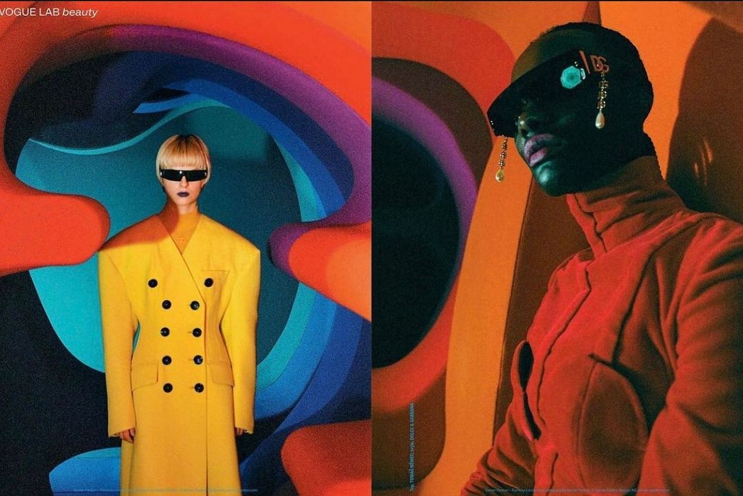 Fashion editorial featuring two models in vividly coloured outfits and backgrounds; one in yellow and the other in red, contrasting in style.