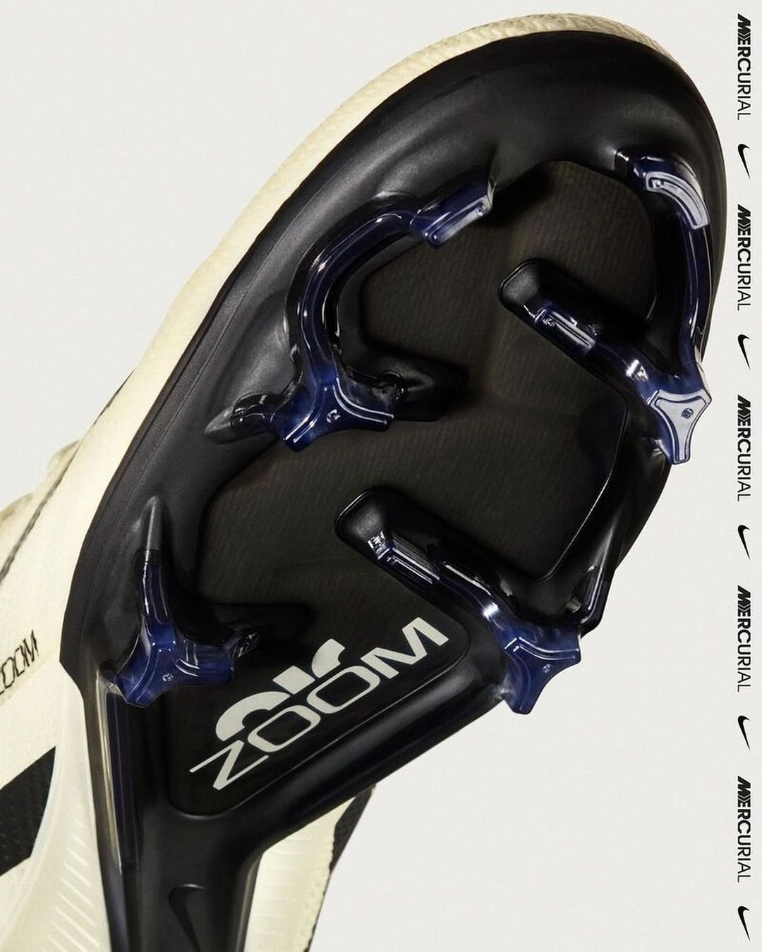 Close-up of a black and white Nike Mercurial soccer shoe sole featuring Zoom technology details against a plain white backdrop.