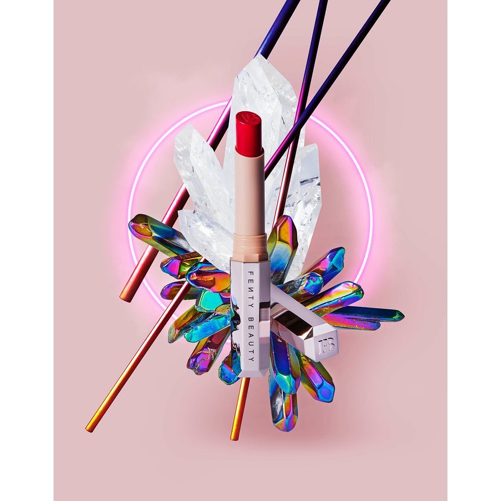 Fenty Beauty lipstick with shimmering crystal accents, bright makeup photography, and pink background for beauty and cosmetic advertising.