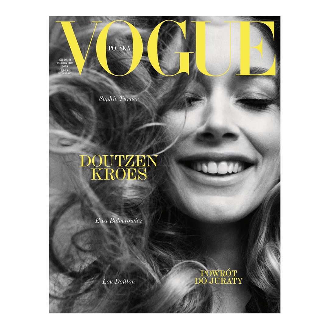 Vogue Polska cover featuring a smiling woman with curly hair. The magazine's name is displayed prominently at the top of the cover.