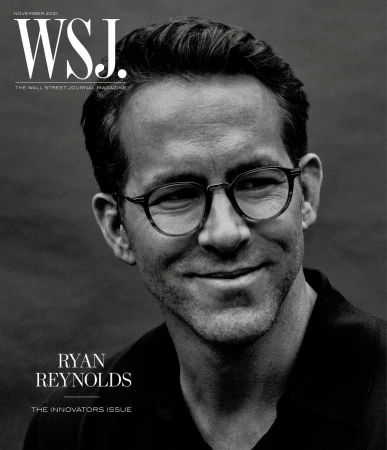 Black and white portrait of Ryan Reynolds on the cover of WSJ. Magazine, November 2021, wearing glasses and a dark shirt.