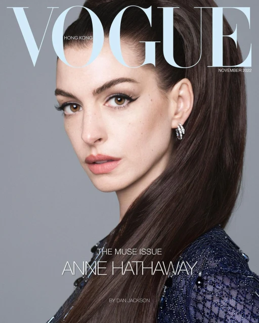 Anne Hathaway graces the cover of Vogue Hong Kong, November 2022 issue. She's styled with bold eyeliner and a sleek, high ponytail.