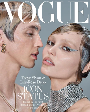 Vogue Australia magazine cover featuring Troye Sivan and Lily-Rose Depp. Close-up of the two celebrities with glamorous makeup and fashion jewelry.