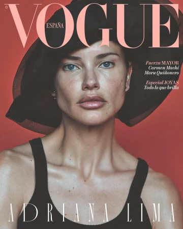 Fashion magazine cover featuring Adriana Lima wearing a black hat and tank top against a red backdrop, with 'Vogue España' at the top.