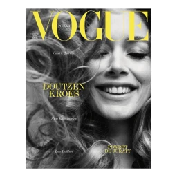 Black and white portrait of a smiling woman with tousled hair for a Vogue Polska magazine cover by photographer Dan Jackson