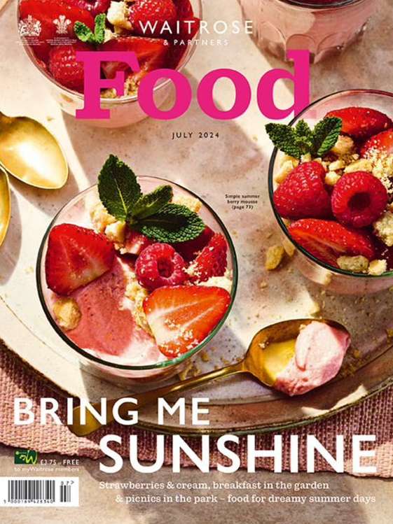 Magazine cover featuring three dessert cups with strawberries, raspberries, crumb toppings, and mint garnish arranged artfully with spoons.