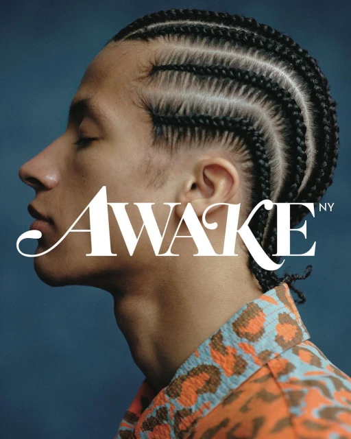 Profile portrait of a young adult male with braided hair wearing a patterned shirt against a blue background with text overlay.