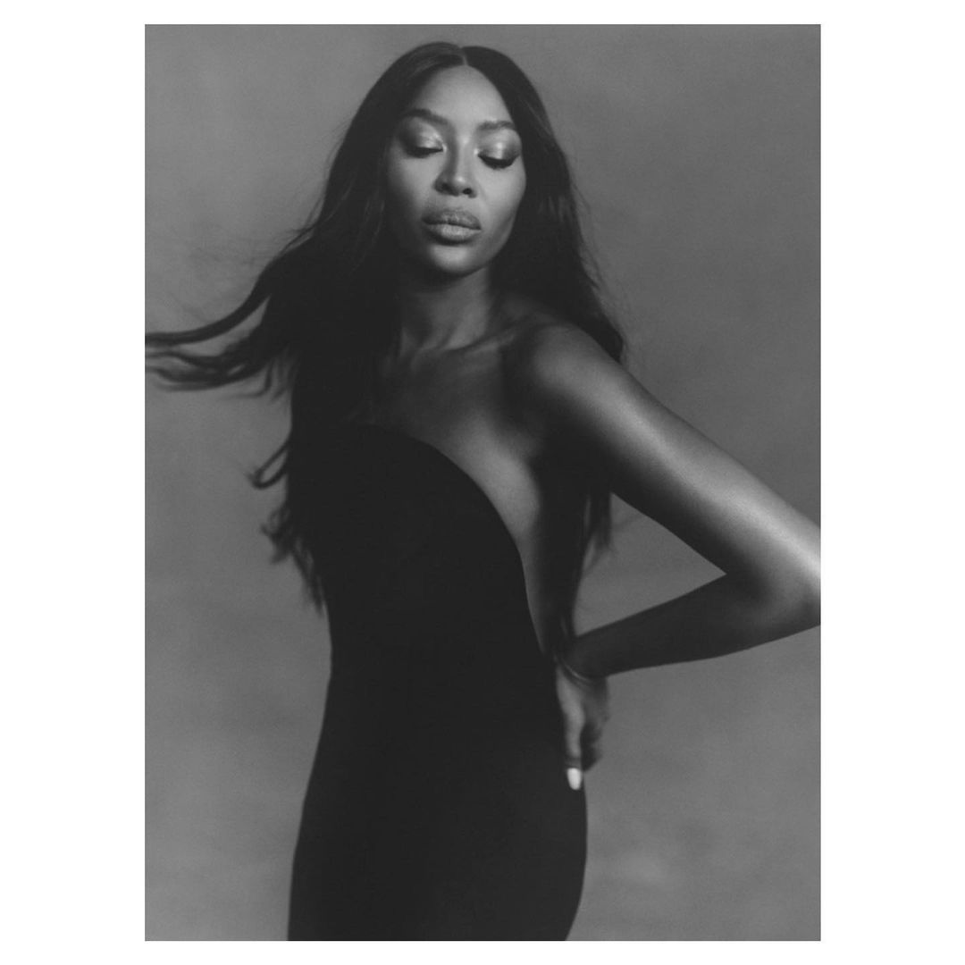 Elegant black and white portrait of an adult woman in a black dress with eyes closed, showcasing fashion and beauty.