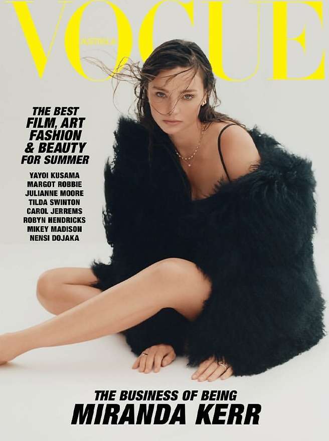 Vogue cover featuring Miranda Kerr wearing a black faux fur coat. The magazine cover has yellow and black text on a white background.