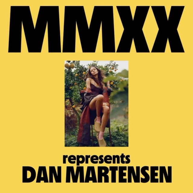 Brunette woman sitting amongst an orange tree on a yellow background with 'MMXX' and 'represents DAN MARTENSEN' in black text.