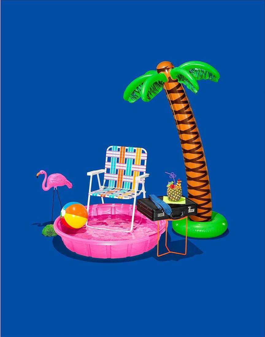 Summer vacation theme with a beach chair in a kiddie pool next to a toy flamingo and a tropical drink, set against a blue backdrop.