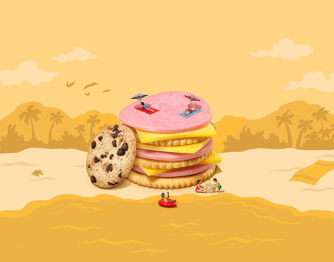 Whimsical beach scene features stacked cookies and crackers, stylized as a resort landscape with miniature sunbathers and a calm, yellow background.