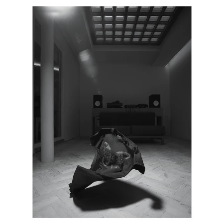 Monochromatic studio shot of a dark shirt with a butterfly design floating mid-air above a light herringbone pattern floor.