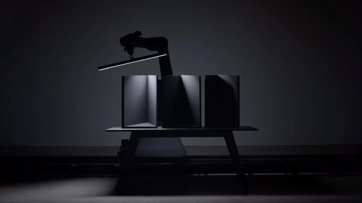 Stylized product photography showcasing three containers on a table, highlighted by dramatic lighting in a dark photo studio.