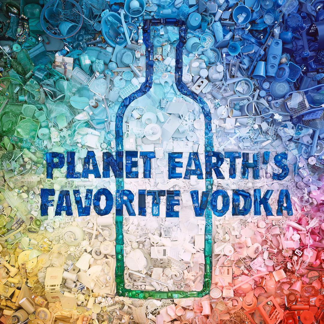 Artistic image of a vodka bottle outline filled with a gradient of plastic debris, against a backdrop of assorted plastic refuse.