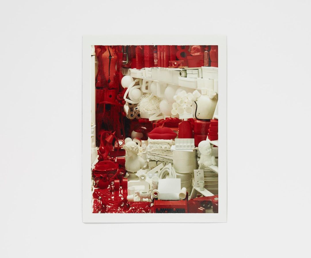 An assortment of red and white objects are arranged in a still life, creating a visually striking composition with contrasting colors.
