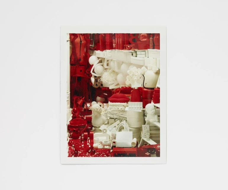 An assortment of red and white objects are arranged in a still life, creating a visually striking composition with contrasting colors.
