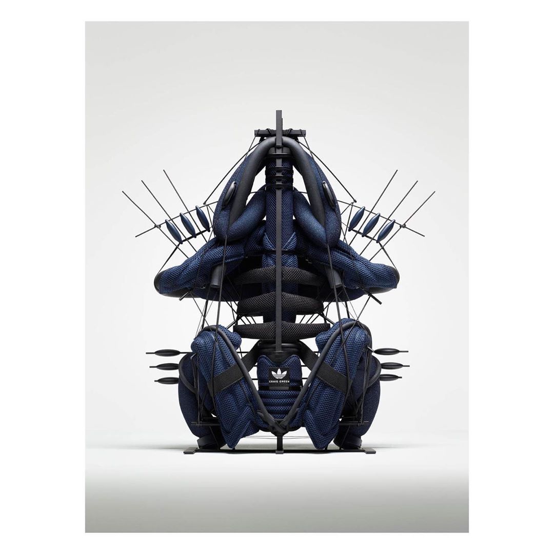 Abstract product photography of a deconstructed Adidas sneaker held together by a metal frame against a white background.