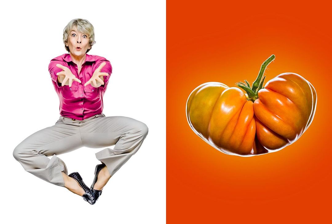 Mature woman jumping with outstretched arms on white, paired with an orange heirloom tomato on an orange backdrop in bright light.