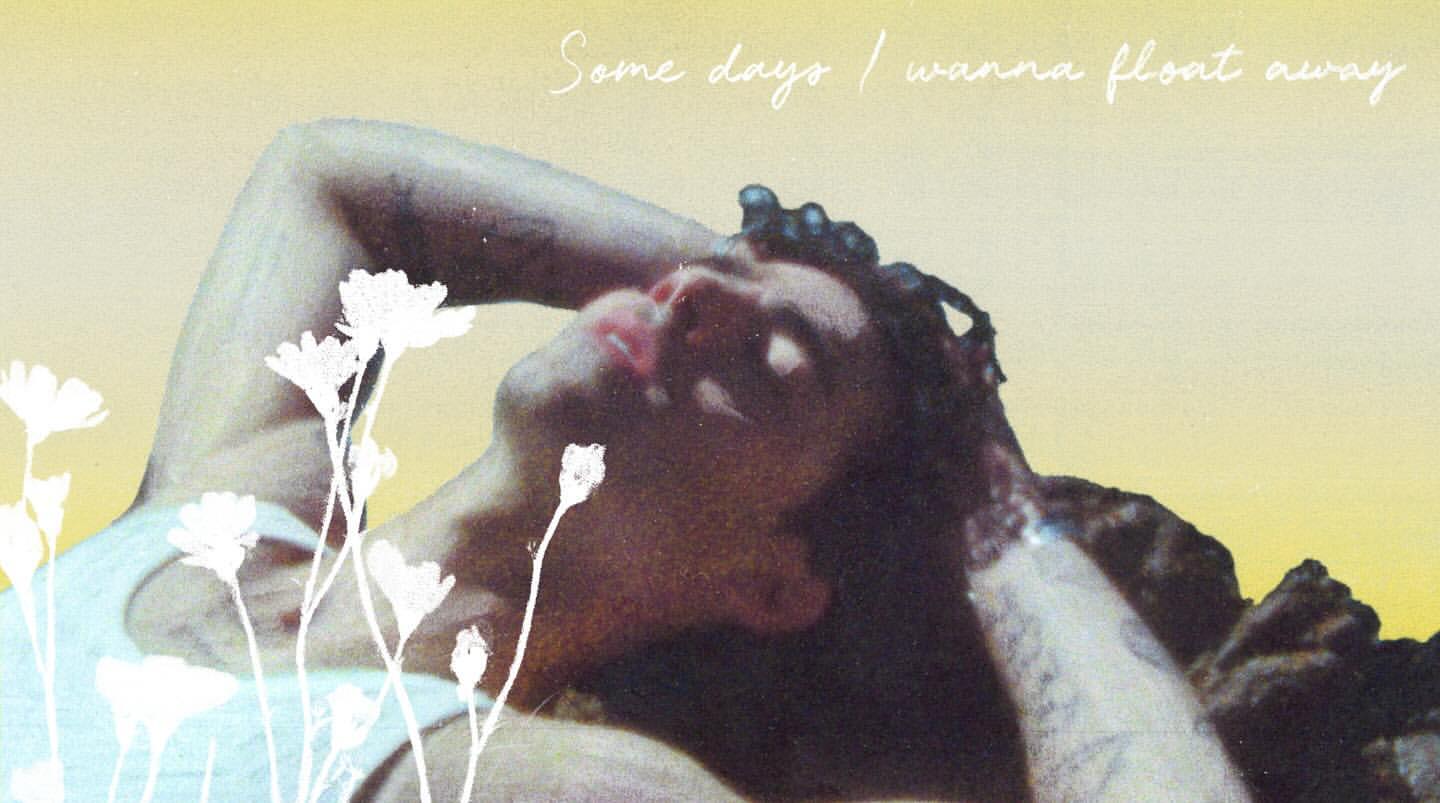 Person laying in the sun with flowers, relaxed and dreamy. Bright yellow light, natural with artistic post-production.