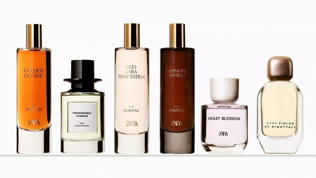 Five Zara perfume bottles with gold and black tops, each containing different colored fragrance, arranged on a bright white background.