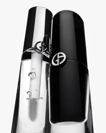 Close-up of two Giorgio Armani beauty products: one black, one clear, against a white background, showcasing the elegant packaging.