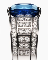 Close-up product photograph of a luxury silver ring featuring a large blue gemstone and diamond pavé band on a white background