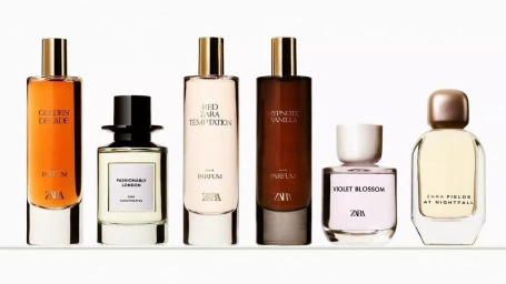 Six Zara perfume bottles of varying shapes and shades lined up in a row against a clean white seamless background.