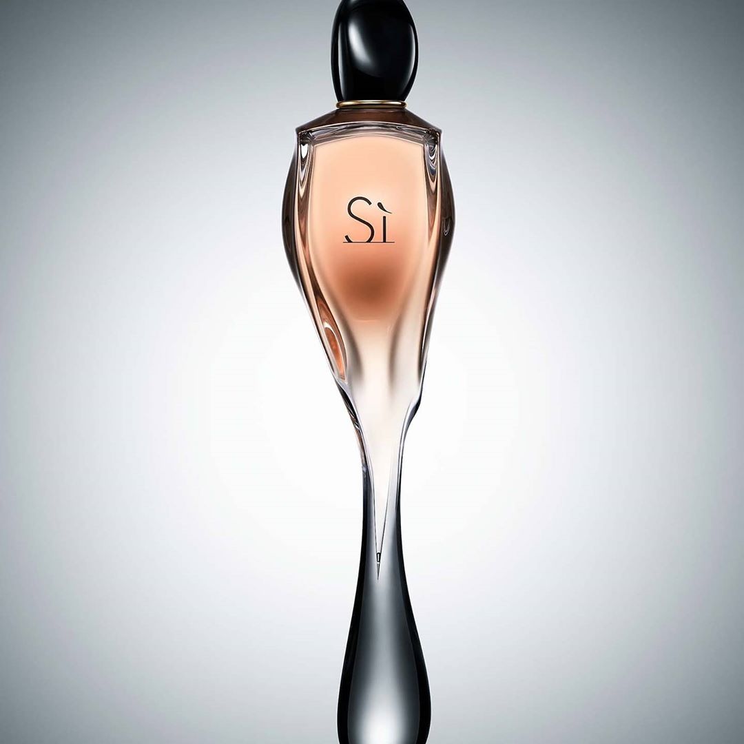 Elegant Giorgio Armani Si perfume bottle on light grey background, highlighting the bottle's unique silhouette and sophisticated design.