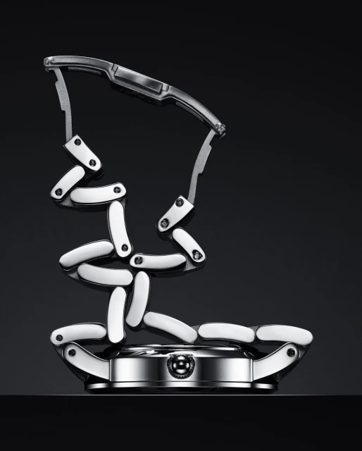 Elevated product shot of a silver and white watch with a deconstructed, sculptural metal band on a dark reflective surface.