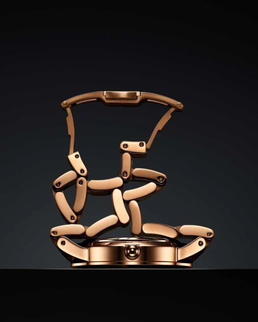 Elegant gold watch presented in parts on a dark background, highlighting the craftsmanship and design of luxury timepieces.