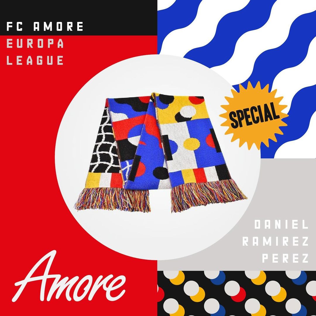 Close-up studio shot of a soccer team scarf with geometric patterns in red, yellow, blue, and black, centered on a white background.