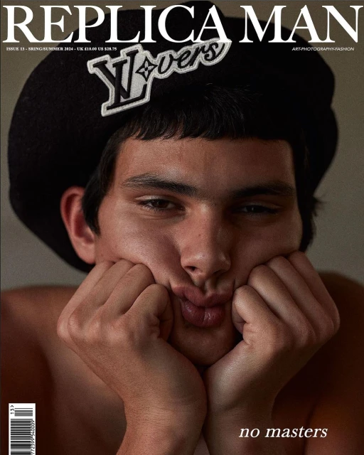 Replica Man magazine cover featuring a young adult male with dark hair and brown eyes posing with hands on his cheeks.
