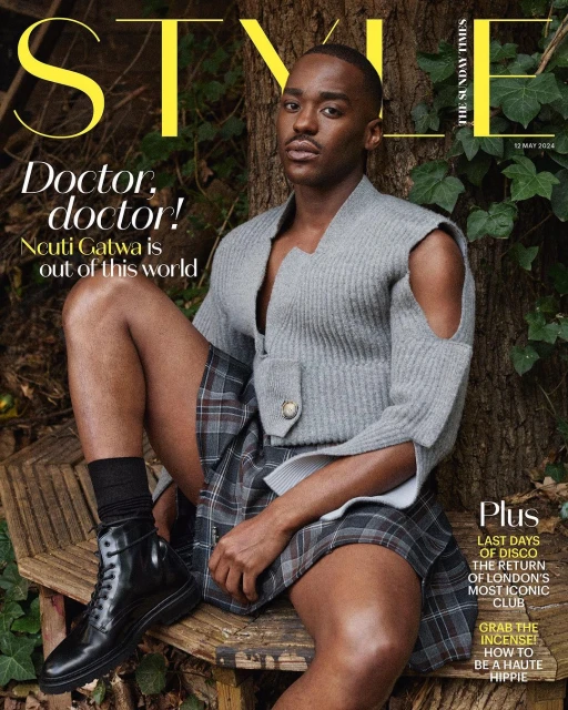 Ncuti Gatwa on the cover of Style magazine, seated on a rustic wooden bench wearing a gray sweater and plaid kilt.