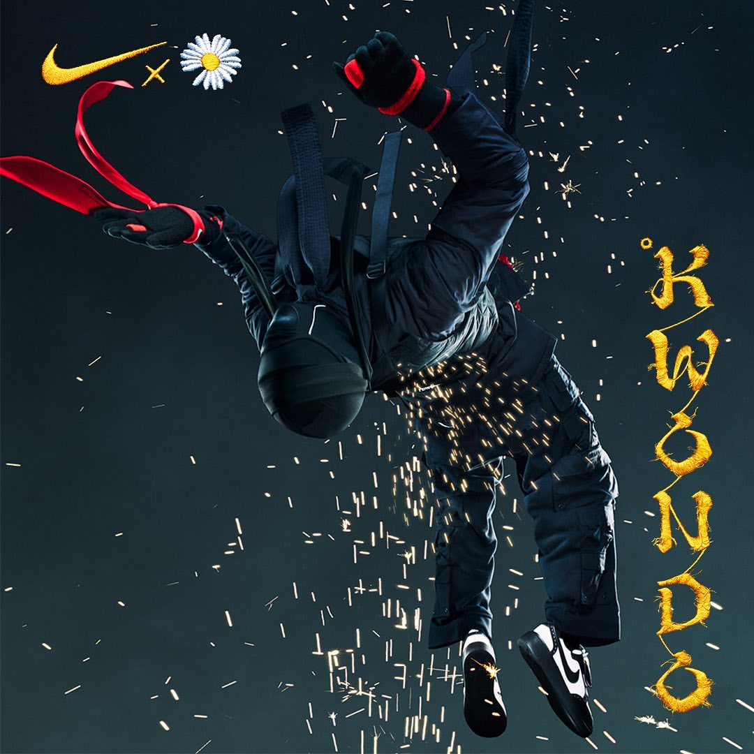 Person in black jumpsuit falling with sparks flying, wearing Nike shoes; daisy graphic and Nike swoosh logo at upper left.