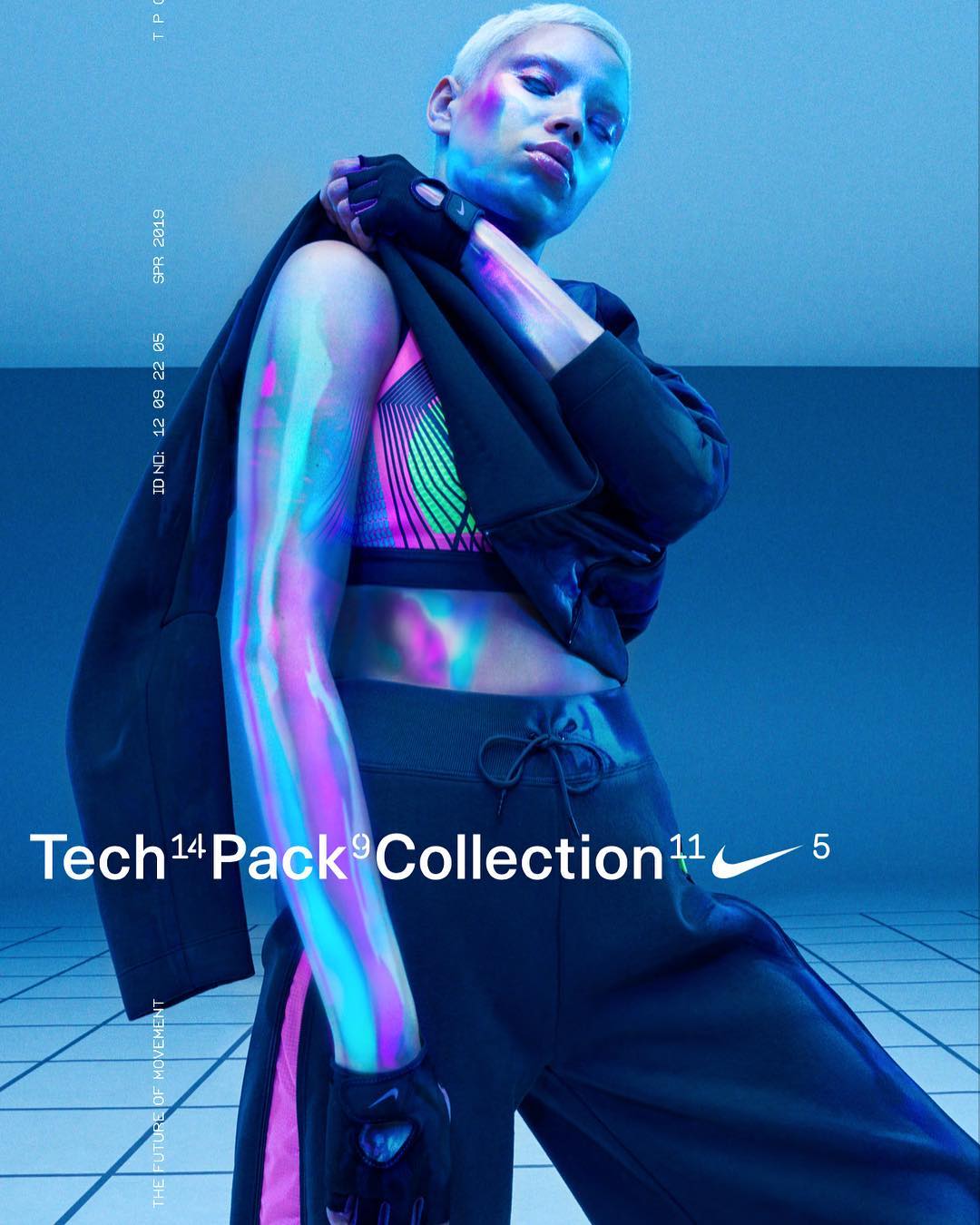 Woman wearing Nike sportswear and jacket in a studio with blue lighting. Fashionable athletic apparel and accessories in a studio setting.