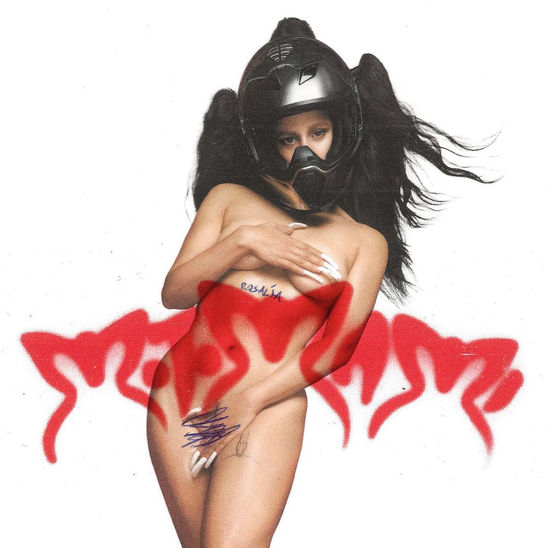 Striking image of a topless female wearing a motorcycle helmet with long braids, posing in front of a white backdrop with red graffiti.