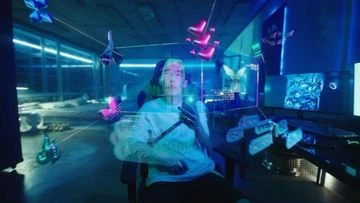 A person sitting in a gaming chair in a room with virtual butterflies floating around them, holding a phone.