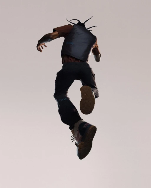 Full shot of a man in streetwear jumping mid-air, with a neutral background showcasing his casual yet stylish urban outfit.