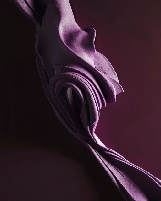 Abstract, flowing fabric in lavender against a dark purple backdrop, showcasing depth and textured textile design in a vertical composition.