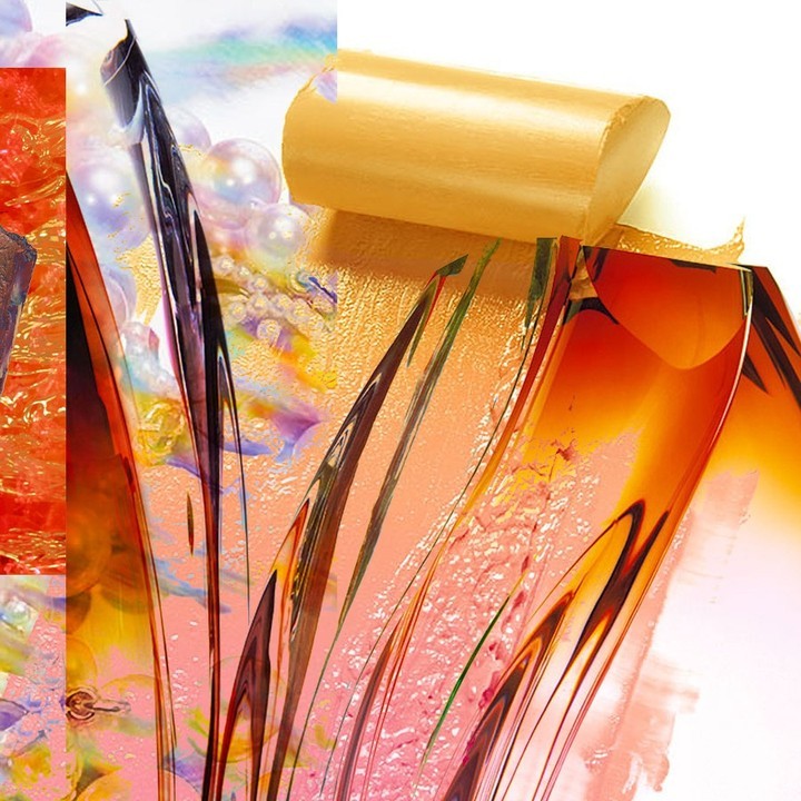 Abstract close-up of swirling gold, orange, and pink with shiny spheres, creating a textured, colorful, and surreal visual.