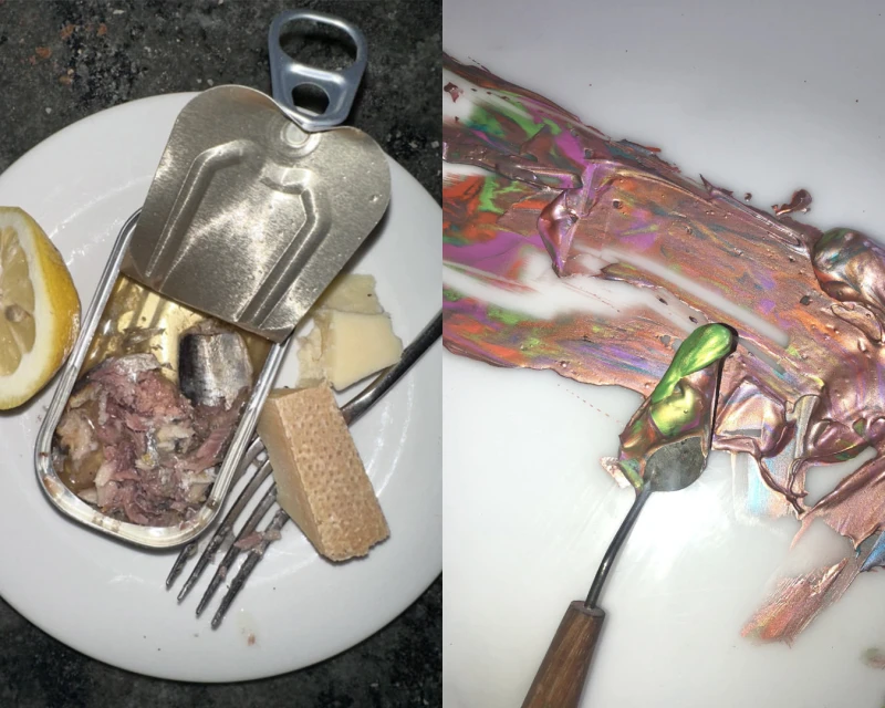 Still life photograph featuring an open sardine can, lemon slice, cheese, fork on a plate, juxtaposed with smears of iridescent paint.