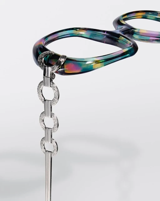 Stylish hair comb on a white background featuring iridescent, reflective, and glossy elements, enhancing the comb's visual appeal.