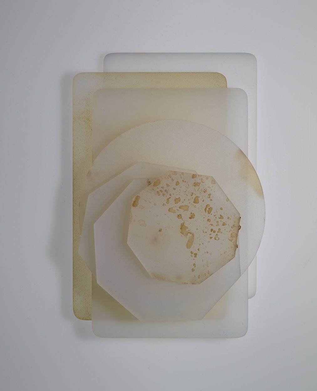 Abstract composition of layered translucent geometric shapes in neutral tones, creating a minimalist and modern art piece.