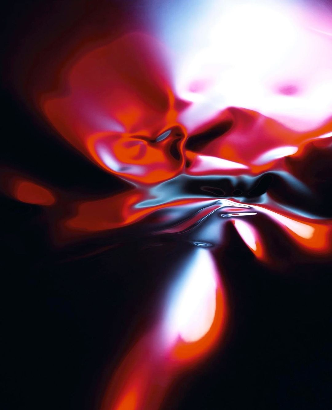 Abstract art with red, white, and blue fluid shapes against a black background, creating a dynamic, colorful visual.