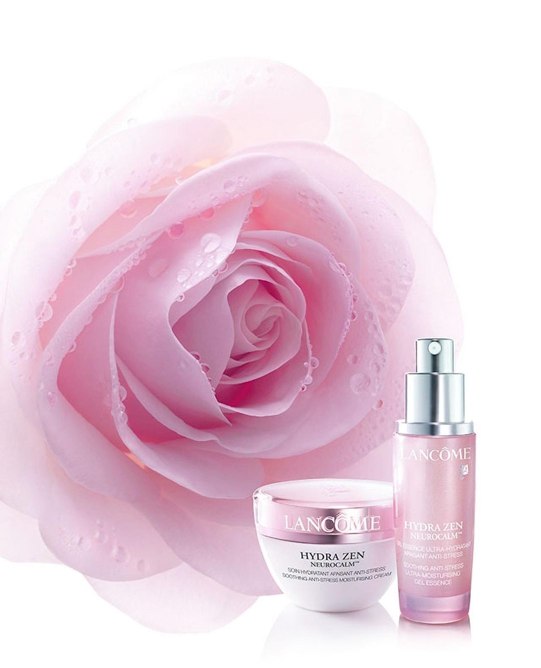 Pink rose backdrop frames Lancome beauty products: a moisturizer and serum against a white background in a cosmetic advertisement.