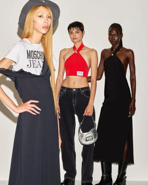 Three fashion models pose indoors against a white background, wearing garments from Moschino Jeans. One model wears a bucket hat.