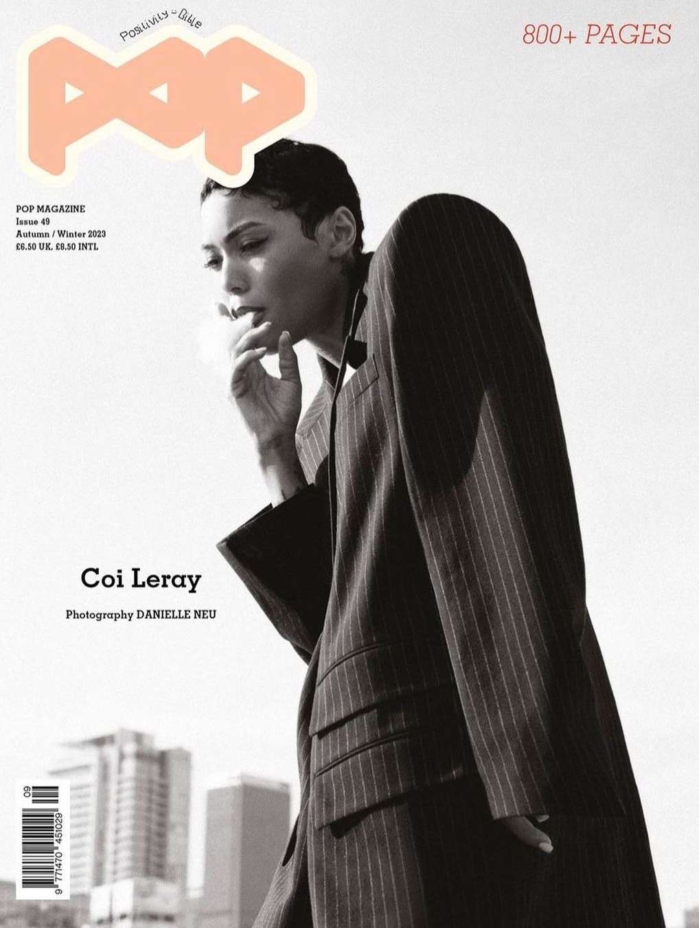 Magazine cover featuring Coi Leray in a pinstripe jacket, set against a muted urban backdrop. The 'POP' logo is prominently displayed.