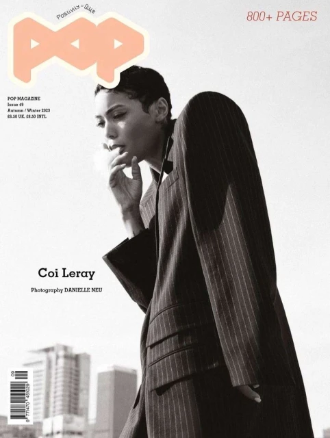 Magazine cover featuring Coi Leray in a pinstripe jacket, set against a muted urban backdrop. The 'POP' logo is prominently displayed.